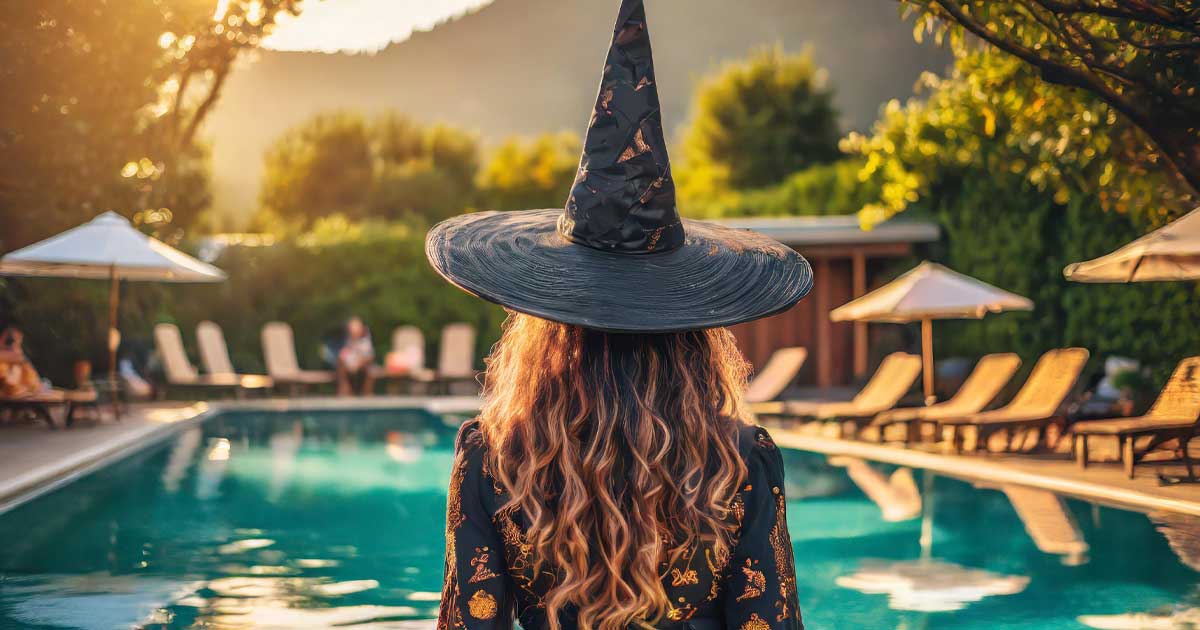 A Woman Dressed As A Witch Attending A Summerween Pool Party